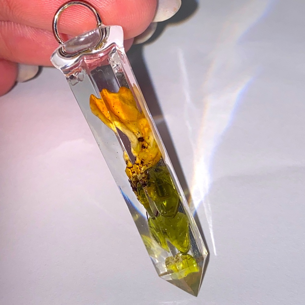 Coral mushroom and tumbled peridot in a clear resin crystal.